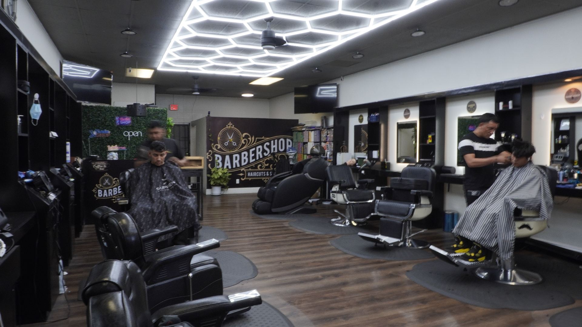 Interior of Sebastian Barber Beauty Salon with hexagonal LED ceiling and barber chairs
